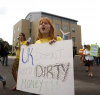 KFTC member Samantha Meador chanted as she marched outside the Wildcat coal lodge on September 13th. Photo Credit Matt Going - Lexington Herald Leader